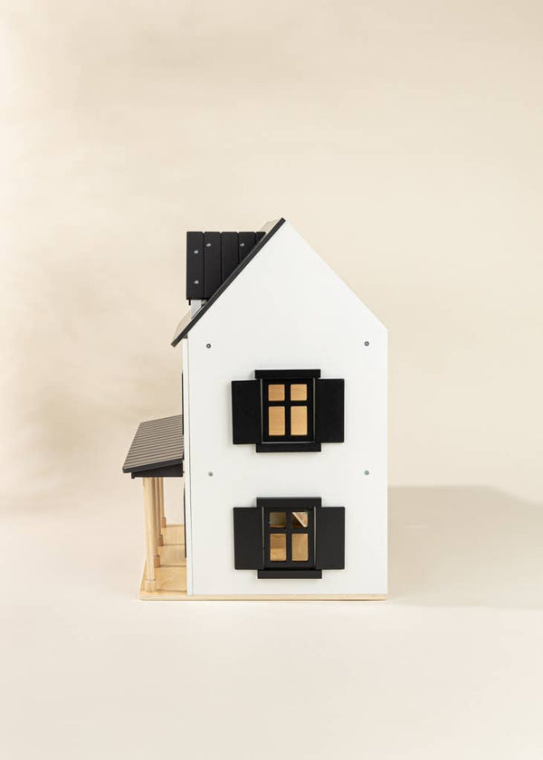 Puppenhaus aus Holz in elegantem Design mit weißen Wänden und schwarzen Fenstern, ideal für kreatives Spielen.