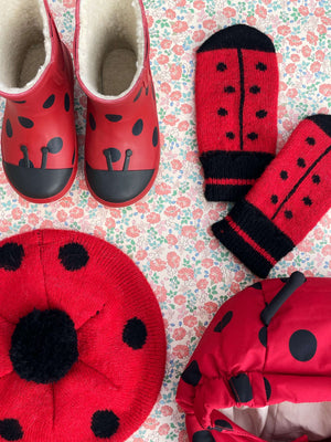 Kind trägt die rote Ladybug Wollmütze im Winter