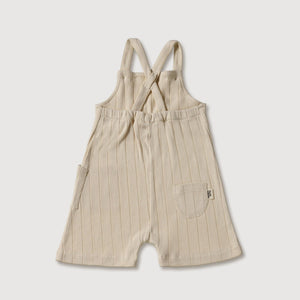 Beige Latzhose aus Rippstrick, 100 % Bio-Baumwolle, mit verstellbaren Trägern und Taschen für Kleinkinder.