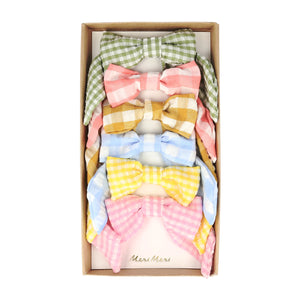 Box of six colorful Gingham hair bows for kids, in mint, mustard yellow, yellow, coral pink, rose, and blue colors, perfect trendy accessory.