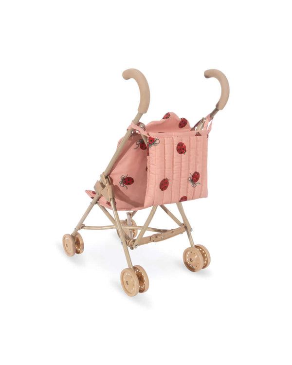 Toy stroller with ladybug design and double wheels for stability by Konges Sløjd.