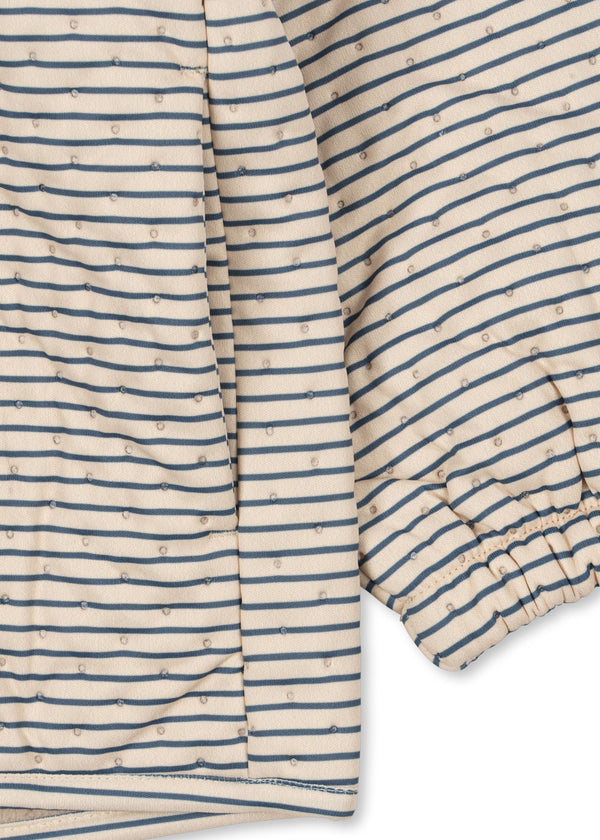 Beige Thermojacke mit blauen Streifen und elastischen Sturmbündchen, ideal für Kinder im Alltag.